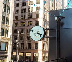 Kindling Sign with downtown Chicago building in background